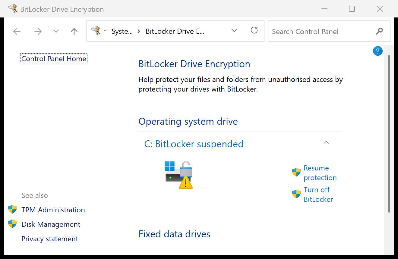 BitLocker Drive Encryption control panel on Windows 11 25H2 showing C: BitLocker suspended with a yellow warning icon and a Resume protection link